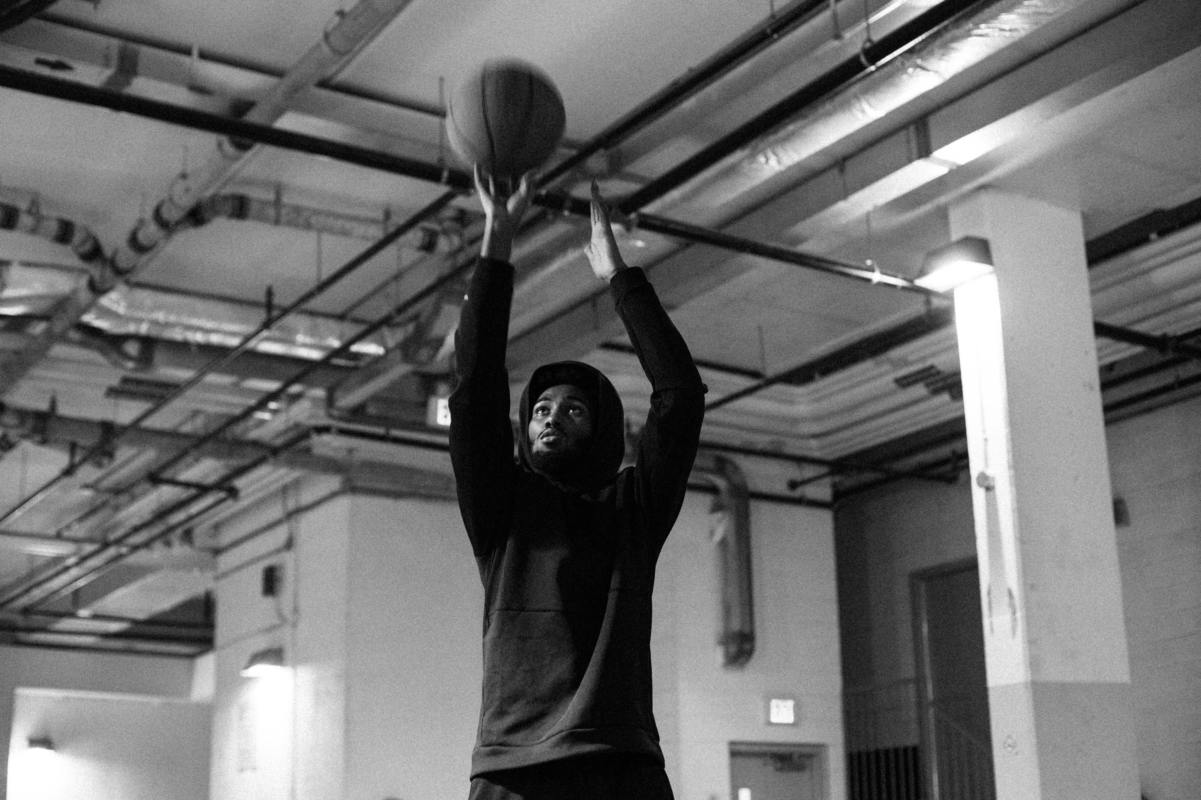 files/man-reaches-high-and-takes-a-shot-with-a-basketball.jpg